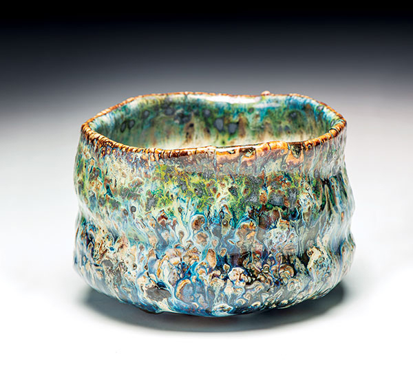 1 Teabowl/Chawan, 3¾ in. (10 cm) in height, Oni-glazed with 10 glazes (application methods included dipping, pouring, brushing, trailing, and spraying); dry shakings of wood ash, volcanic ash, colorants, fluxes, and frits; reduction fired in a gas kiln to cone 9–10. 