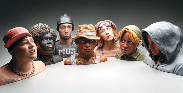 Figures/busts from the “Color Theory” exhibition. From left to right: He’s cool but he doesn’t really act black; The Crossroads; The Blue Wall; I can’t let you in the club with that hat bro; How do I fit into this?; About the best we can do for ya; The Threat. All pieces: various dimensions, earthenware, underglaze, gold luster, acrylic wash, oils, 2016.