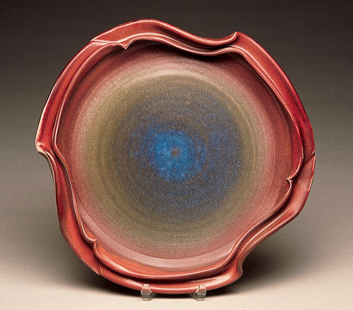 Undulating Rim Platter, 16 inches in diameter, wheel thrown and altered white stoneware, with Blue-Green/Copper Red Glaze sprayed over scrap glaze, red to Cone 6 in reduction.