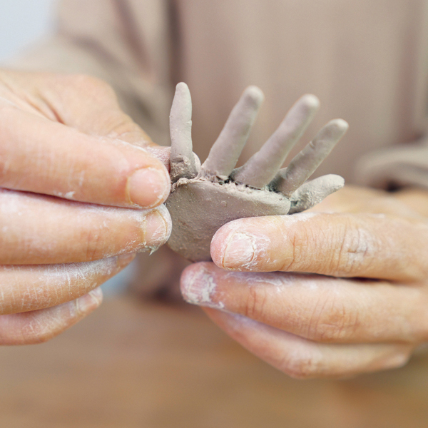 6 Attach each finger coil to the palm slab by slipping and scoring.