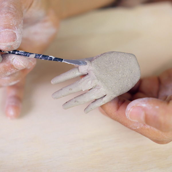 8 Add and blend extra clay to the top of the hand for knuckles.