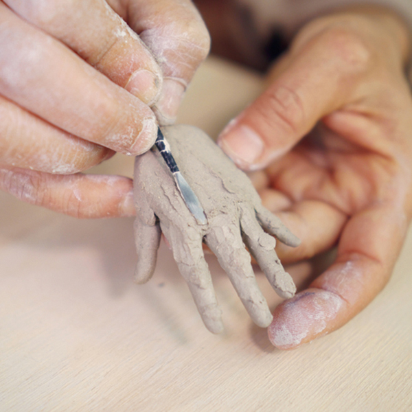 9 Add small coils for metacarpal bones across the top of the palm.