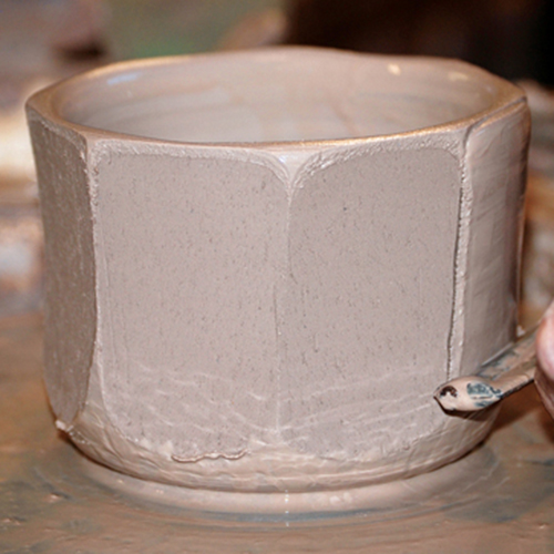 1 For straight facets, throw a vertical form and draw a cheese cutter from the rim down toward the base. 