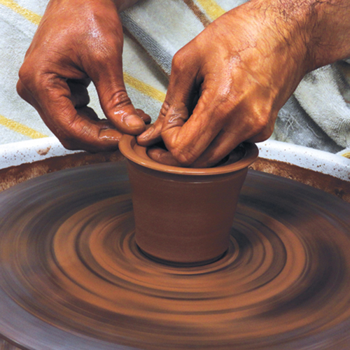 3 Throw a small cup for the infuser. Leave extra clay at the rim to make a gallery for the lid.