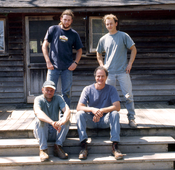 Mark Hewitt sits (front right) with Martin Simpson (front left), a potter from England. Mark’s apprentices stand: Daniel Johnston to the left, Eric Smith to the right, 2000.