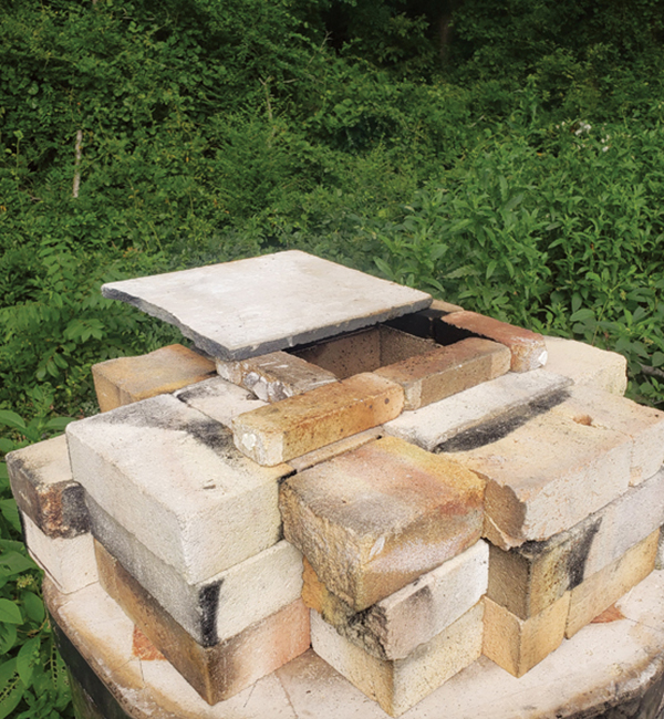 9 Stack soft brick around the chimney hole. Use an old kiln shelf for a damper.