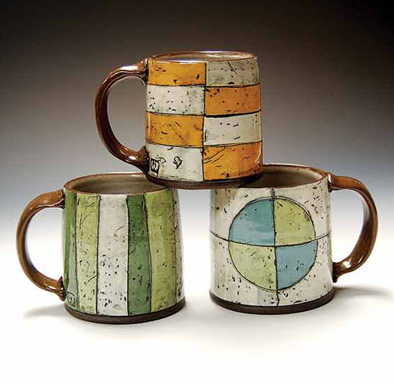 5 Three mugs, 4 in. (10 cm) in height each, dark-brown stoneware with monoprint slip transfer, fired to cone 5 in oxidation, 2022. 