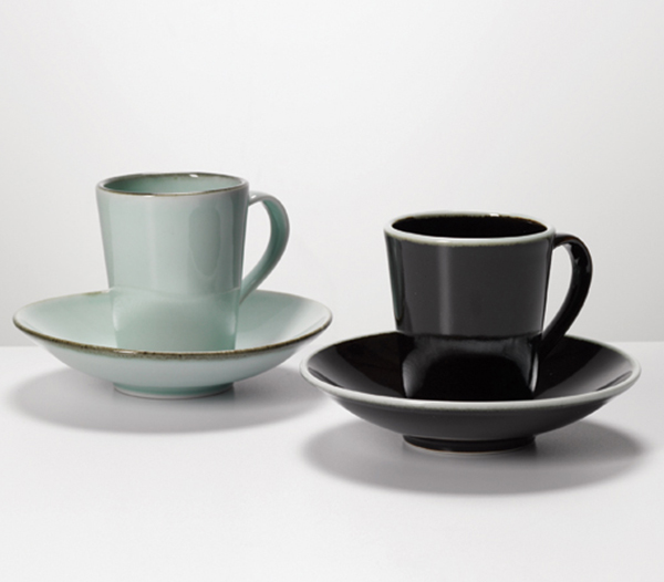 4 Chris Keenan’s 2 x Cup and Saucer, 4⅓ in. (11 cm) in height, Limoges porcelain, tenmoku and celadon glazes. Photo: Michael Harvey.