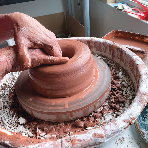 2 Open the clay and compress the bottom, allowing ½ inch of clay to remain.