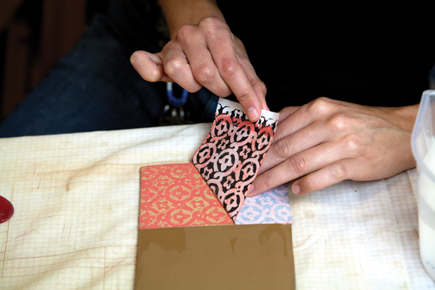 Peel a corner back to check how well the pattern is transferring. Brush more water on the back or continue to rub if necessary. The clarity of the transferred pattern depends on the balance of these techniques.