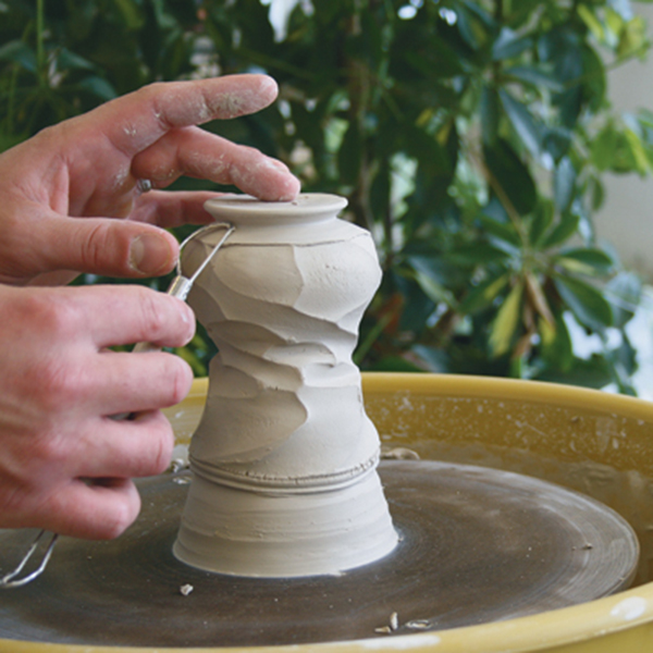 5 In order to retain the freshness of the undulating rim, trim the pieces on a mound of clay.