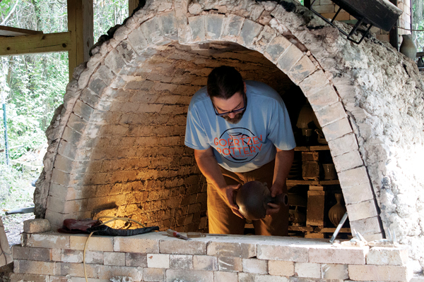 1 Mark Goertzen unloading pots from his wood kiln in Constantine, Michigan. 