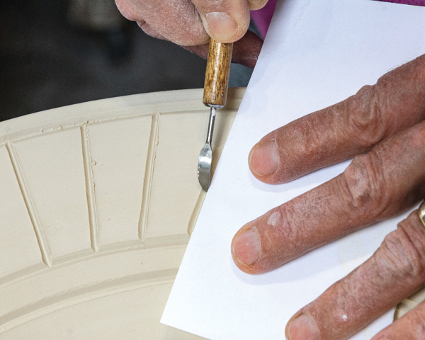 1 Use the straight edge of a piece of paper to guide your hand when carving.