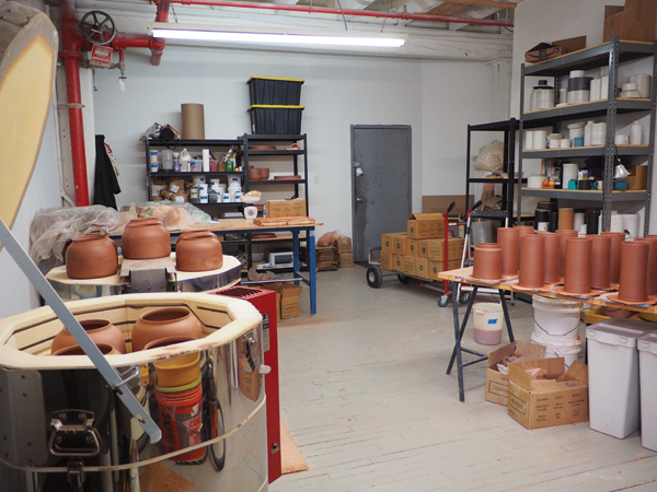 6 Vessels on the left being loaded into the kiln for their first firing; on the right there are freshly thrown cylinders.