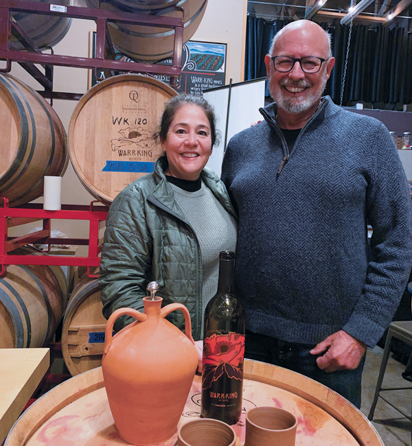 Lisa Warr-King Packer and Harlan Falkin tasting wine from his amphora, 2022.