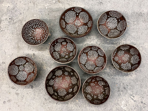 9 Bowls, wheel-thrown stoneware, white slip, inlay, clear and multiple colored glazes, reduction fired to cone 10 in a gas kiln.