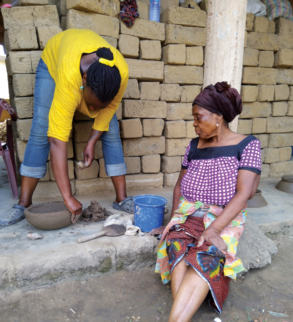 3 Master-level Ghanaian potter assesses Yinka Orafidiya’s skill progression during her apprenticeship in the village of Vume, Ghana, 2018. 