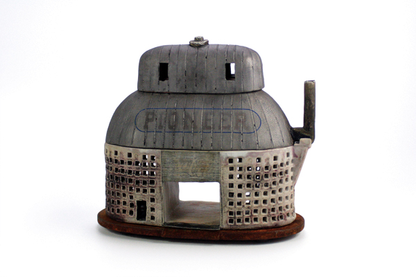 2 PIONEEER Corn Crib Teapot, 13 in. (33 cm) in height, stoneware, Toshiko Black and shino glazes, wood fired to cone 10, decals fired to cone 017, sandblasted, rusted-patina iron base. 