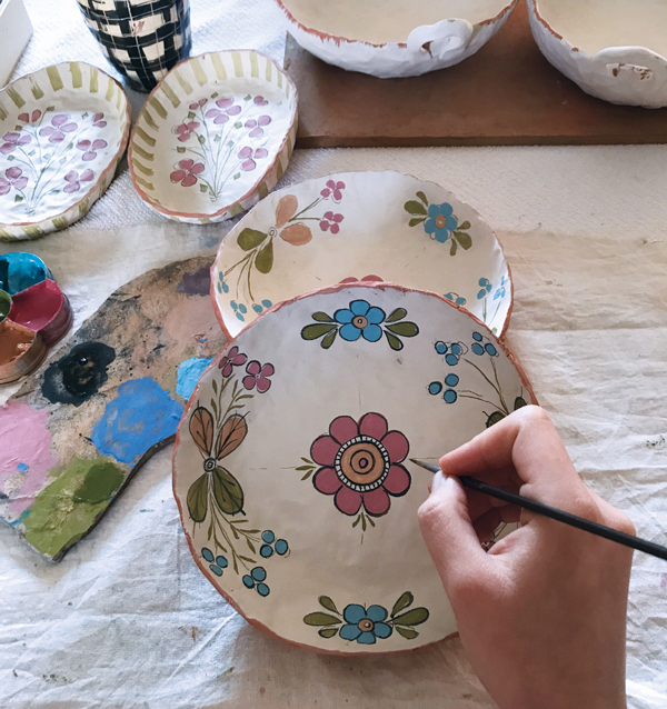 1 Didem Firat decorating bisque-fired pots with underglazes. The next step is applying a clear glaze and then glaze firing to 1922°F (1050°C). 