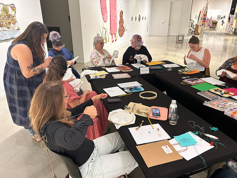 Image of participants making crafts in an embroidery workshop with Taryn Singleton