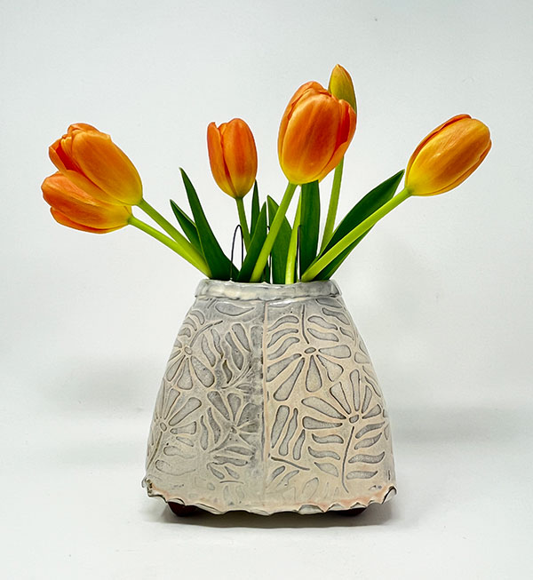 Image of a ceramic vase by Jen Harnetty Ceramics with tulips in it.