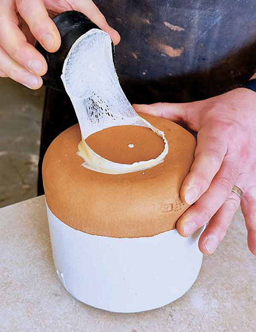 4 Once the glaze is dry, peel off the handle, then remove residual latex.