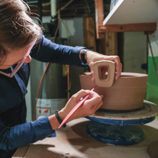 8 Trace the bottom edge of the handle with a needle tool onto the side of the pot.