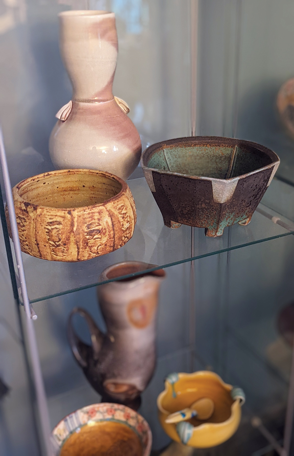 2 A display case of pots, including Marotz’ first purchase of handmade pottery, a Warren Mackenzie bowl (top left).