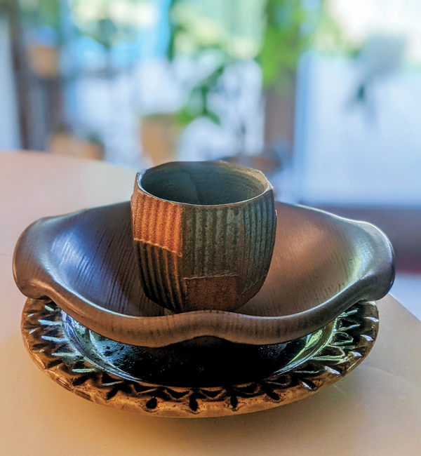 7 A stack of pots about to be used for a meal (Alana Cuellar plate, Steven Rolf bowl, Jeff Oestreich cup). 