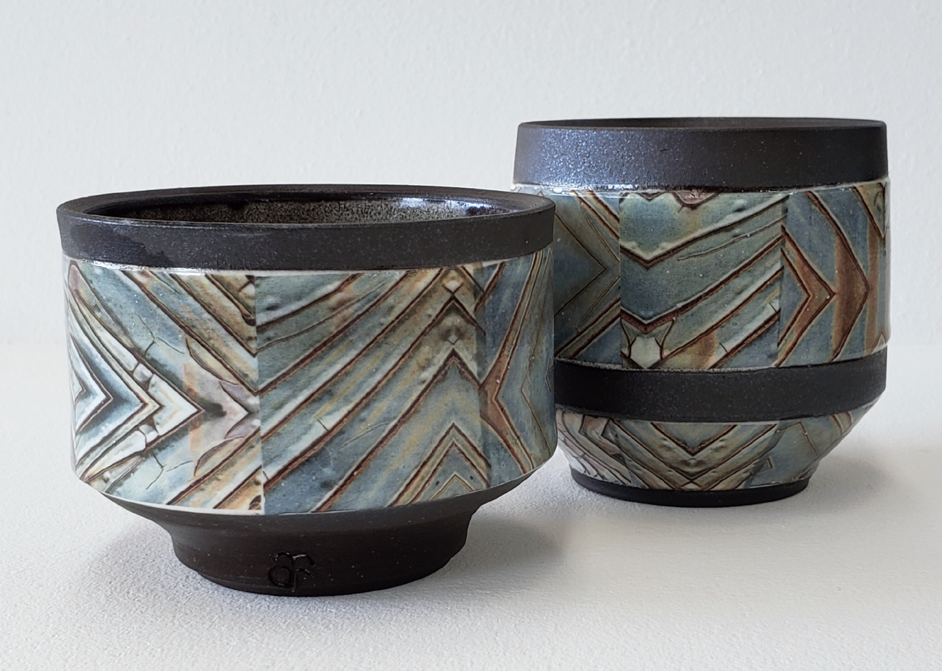 2 Dark brown cups, to 5 in. (12 cm) in height, stoneware, color waterslide decals, fired to cone 6 and then cone 013 in an electric kiln. 
