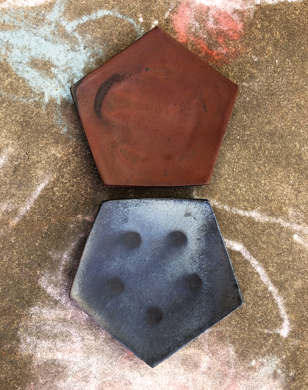 8 Lindsay Oesterritter’s pentagon plates, 7½ in. (19 cm) in width, iron-rich stoneware. 
