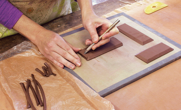 12 The slabs used for constructing the brick are stiff leather hard and beveled on all sides of the slab. The bevel cuttings are saved to be later used as seam fillers.