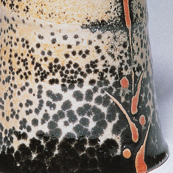 An example of carbon trapped beneath an American Shino glaze on porcelain. The piece is by the late Malcolm Davis. The particular Shino glaze recipe shown is one of literally dozens used or published by Davis. He was constantly adjusting the proportions and amounts of flux and clay ingredients in the recipe, looking for the elusive “perfect” Shino.