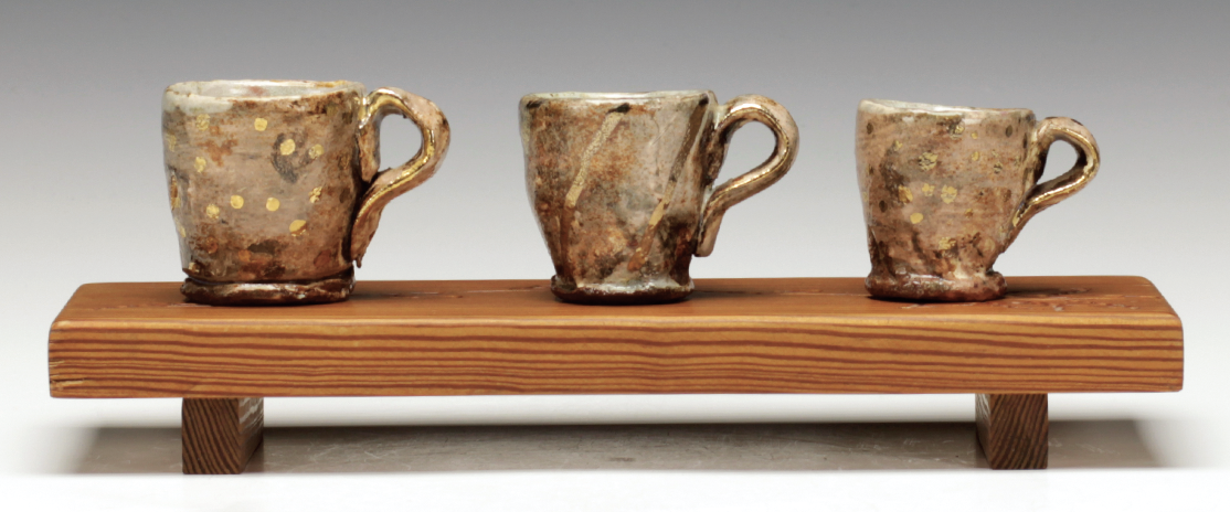 7 Cups with tray, cups to 21/4 in. (6 cm) in height, tray 91/2 in. (24 cm) in length, wheel-thrown earthenware, Redneck Majolica, underglaze, wood fired/multi fired, gold luster, recycled fir, engraving. 