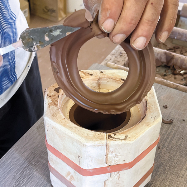 3 Trim the reservoir away, then allow the piece to firm up until it pulls away from the mold.