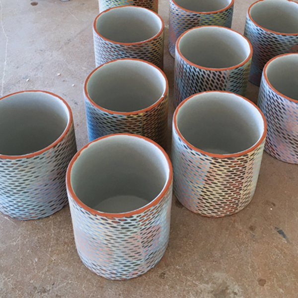 6 Bisque-fired mugs with liner glaze. Note the orientation of the plastic mesh can be rotated to create a variation of the etched pattern.