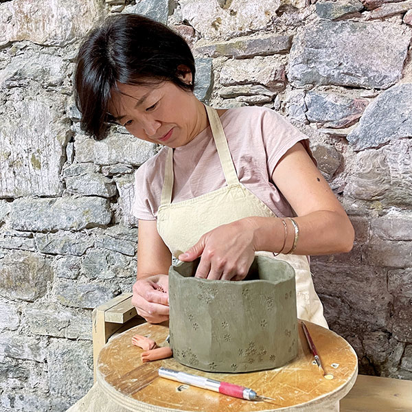3 Minsoo Yuh working on a vessel in her studio. 
