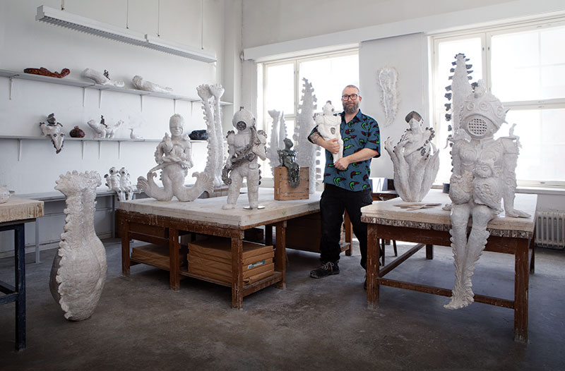 Image of Sakari Kannosto with finished work in his ceramic sculpture studio.