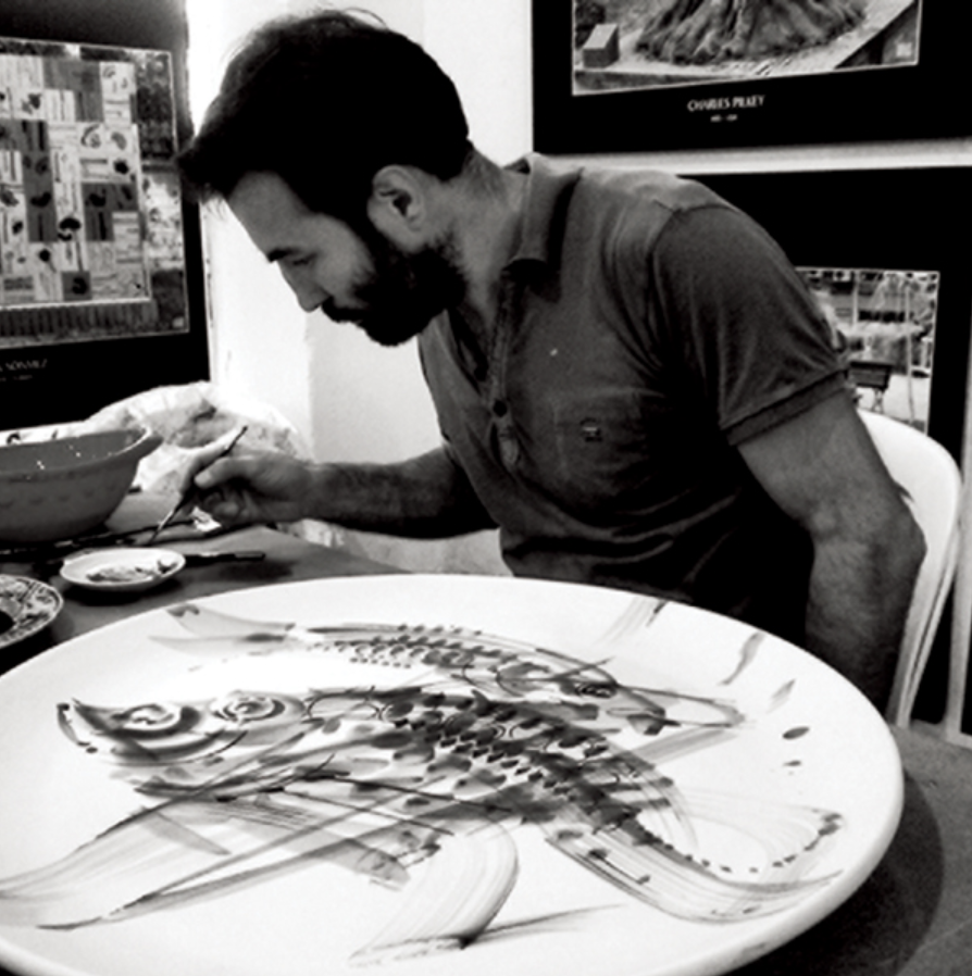 1 Semih Kaplan painting spontaneous underglaze decoration on a tile-clay wall plate.
