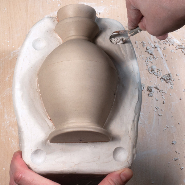 5 Create keys in the plaster of the first half of the mold using a trimming tool.