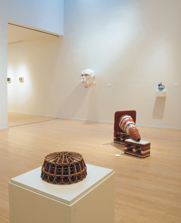 1 Souvenirs from the Future, exhibition view, at the Lawrence Arts Center. Foreground: Brian Harper’s Scaffolding Series (With Stack of Four JCPenney HomeTM Collection 10-inch Dinner Plates). Middle ground: sculpture by John Zimmerman. Photo: Lawrence Arts Center.