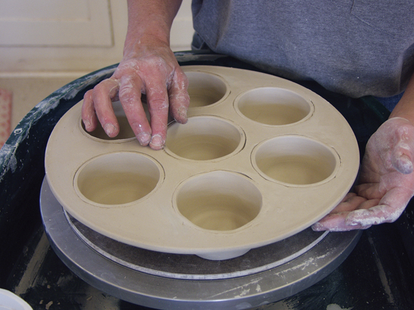6 Flip the muffin pan over and carefully blend the edge of each cup into the top of the slab. 