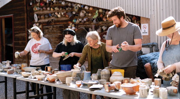 3 Stuart Gair’s Understanding Soda Firing workshop participants look over their finished work in the kiln yard at Anderson Ranch Arts Center. 