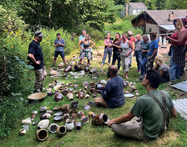 1 Workshop participants with instructor Ben Owen III discussing work just unloaded from the Peters Valley anagama firing, August 2022.