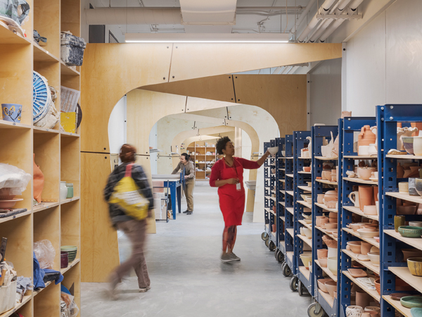 3 The Clay Studio’s school hallway with ware carts in use for student and in-house artists’ work. The large common corridor is designed to promote engagement across programs. Pictured: Guest Artist Stefani Threet. Photo: Sam Oberter. 