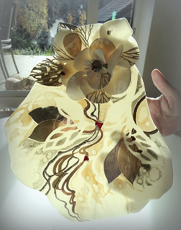 2 Joanna Świerczek creates jewelry with clay flowers. She attaches hand-formed petals to a slab, both made from the same Scarva clay body. She often embellishes parts with additional slip.