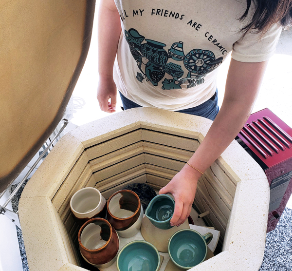 5 Kiln owner unloading glazed ceramics. Photo: @curvypotshandmade.**