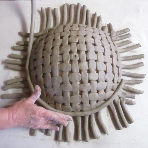 4 Attach a coil rim to the outside circumference of the woven platter. Cut the ends that will be joined at a 45° angle.