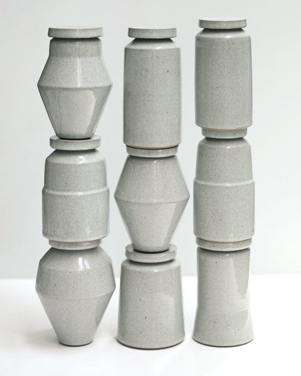  11 Stacked white lidded vessels, 6¼ in. (16 cm) in height (each), stoneware and white crackle glaze, 2022. 