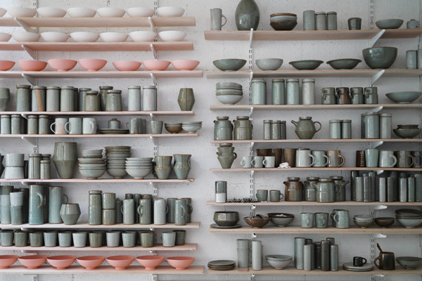 1 The shelves in Florian Gadsby’s studio filled with pots. Most are fired, others (pink and white) are awaiting the kiln.